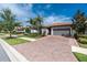 Charming single-story home with a well-manicured lawn, brick driveway, and inviting curb appeal at 1530 Hyssop Loop, North Port, FL 34289