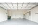 Spacious garage with clean, painted walls, ample storage space, and convenient utility sink at 1530 Hyssop Loop, North Port, FL 34289