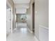Hallway featuring a view of the living room and neutral walls at 1530 Hyssop Loop, North Port, FL 34289