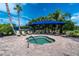 Outdoor hot tub with blue shade, lounge chairs, and paved brick flooring perfect for relaxation on a sunny day at 1530 Hyssop Loop, North Port, FL 34289