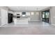 Kitchen features white cabinets, black appliances, granite countertops, and a kitchen island overlooking the living area at 1530 Hyssop Loop, North Port, FL 34289