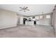 Open floor plan showcasing the living room and kitchen with a ceiling fan and hanging decorative light at 1530 Hyssop Loop, North Port, FL 34289