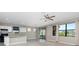 Open floor plan featuring carpet flooring, a ceiling fan, and view of the kitchen at 1530 Hyssop Loop, North Port, FL 34289