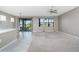Open floor plan featuring a living area with carpet flooring, windows, and views into the lanai at 1530 Hyssop Loop, North Port, FL 34289