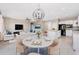 Open concept living space with stylish lighting, modern furnishings, and an eat-in kitchen at 1530 Hyssop Loop, North Port, FL 34289