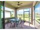 A screened patio with a table and chairs overlooking lush landscaping at 1530 Hyssop Loop, North Port, FL 34289