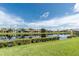 Community pond surrounded by lush green lawns and neighborhood homes reflecting off the water at 1530 Hyssop Loop, North Port, FL 34289