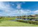 Community pond surrounded by lush green lawns and neighborhood homes at 1530 Hyssop Loop, North Port, FL 34289