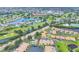 An aerial view shows a community surrounded by lush golf courses and scenic water features at 2004 Longpointe Cir # E2, Venice, FL 34293