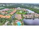An aerial view showcases a beautiful waterfront community with lush greenery and water views at 2004 Longpointe Cir # E2, Venice, FL 34293