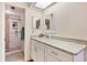 Bathroom with a glass door shower and a granite topped vanity at 2004 Longpointe Cir # E2, Venice, FL 34293