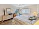Bedroom with a queen size bed, desk and chair and views of the backyard at 2004 Longpointe Cir # E2, Venice, FL 34293