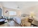 Bedroom features a queen size bed, desk and a ceiling fan at 2004 Longpointe Cir # E2, Venice, FL 34293