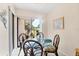 Dining area featuring a glass table and access to the outdoor patio at 2004 Longpointe Cir # E2, Venice, FL 34293