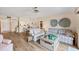 Cozy living room with a ceiling fan, wood-look flooring, and access to the dining area at 2004 Longpointe Cir # E2, Venice, FL 34293
