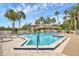 Bright community pool with palm trees and lounge chairs offering residents a refreshing and relaxing outdoor space at 2004 Longpointe Cir # E2, Venice, FL 34293