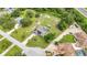 Aerial view showcases a home with a pool, patio, solar panels, and an extra large backyard with sheds at 2541 Northway Dr, Venice, FL 34292