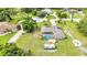 An aerial of the property showing the pool, outdoor patio, solar panels, and surrounding trees at 2541 Northway Dr, Venice, FL 34292