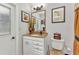 Elegant bathroom featuring vanity, mirror, and pictures, enhanced by soft lighting at 2541 Northway Dr, Venice, FL 34292