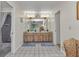 Bathroom features a dual sink vanity, tile flooring, and access to a shower and toilet room at 2541 Northway Dr, Venice, FL 34292