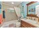Cozy bathroom featuring a tub, shower, and vanity with a sink, enhanced by a charming, nautical decor at 2541 Northway Dr, Venice, FL 34292