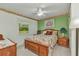 Comfortable bedroom with floral wallpaper, a ceiling fan, and a window overlooking the outdoors at 2541 Northway Dr, Venice, FL 34292