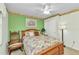 Cozy bedroom featuring a wooden bed frame, ceiling fan, and floral wallpaper, creating a comfortable space at 2541 Northway Dr, Venice, FL 34292