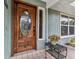 Stunning wooden front door with decorative glass, complemented by colorful floral accents at 2541 Northway Dr, Venice, FL 34292