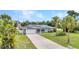 Charming single-story home with a well-manicured lawn, solar panels, and an American flag at 2541 Northway Dr, Venice, FL 34292