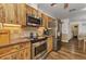 Well-lit kitchen featuring wood cabinets, stainless steel appliances, and ample counter space at 2541 Northway Dr, Venice, FL 34292