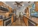 Rustic kitchen with wood cabinetry, stainless steel appliances, and a view of the pool at 2541 Northway Dr, Venice, FL 34292
