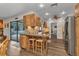Kitchen with seating area, natural wood cabinetry, and view to lanai through sliding glass door at 2541 Northway Dr, Venice, FL 34292