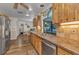 Kitchen featuring wood cabinetry, stainless steel appliances, and a view of the pool area at 2541 Northway Dr, Venice, FL 34292