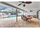 Covered lanai featuring brick flooring, ceiling fans, outdoor furniture, and a full view of the pool at 2541 Northway Dr, Venice, FL 34292