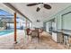 Covered lanai featuring brick flooring, ceiling fans, outdoor furniture, and a full view of the pool at 2541 Northway Dr, Venice, FL 34292