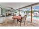 Covered lanai featuring brick flooring, ceiling fans, outdoor furniture, and a full view of the pool at 2541 Northway Dr, Venice, FL 34292