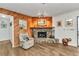 Inviting living room with a stone fireplace, wood paneling, and comfortable armchair at 2541 Northway Dr, Venice, FL 34292