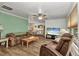 Comfortable living room with modern flooring, a ceiling fan, and ample natural light at 2541 Northway Dr, Venice, FL 34292