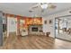 Bright living room with a stone fireplace, wood paneling, and access to outdoor patio at 2541 Northway Dr, Venice, FL 34292