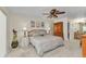 This main bedroom offers a ceiling fan, neutral carpet, and an ensuite bath at 2541 Northway Dr, Venice, FL 34292