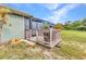 Cozy covered patio features wood railings, a grill, and convenient access to the outdoors at 2541 Northway Dr, Venice, FL 34292
