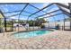 View of the refreshing screened-in pool area, complete with brick paving and clear blue water at 2541 Northway Dr, Venice, FL 34292