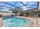 Inviting pool with screened enclosure offers a private outdoor space for relaxation and recreation at 2541 Northway Dr, Venice, FL 34292