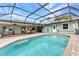 Inviting pool with screened enclosure offers a private outdoor space for relaxation and recreation at 2541 Northway Dr, Venice, FL 34292