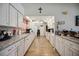 Bright kitchen featuring modern appliances, white cabinets, laminate floors, and durable counters at 27581 Tierra Del Fuego Cir, Punta Gorda, FL 33983