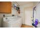 Functional laundry room with a washing machine, dryer, and storage space at 27581 Tierra Del Fuego Cir, Punta Gorda, FL 33983
