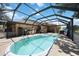 Inviting screened-in pool with ample deck space for outdoor relaxation and entertaining at 27581 Tierra Del Fuego Cir, Punta Gorda, FL 33983