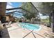 Screened-in pool featuring a ladder entry and a spacious area for seating and plants at 27581 Tierra Del Fuego Cir, Punta Gorda, FL 33983