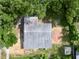 Aerial view of the home, roof, and yard with surrounding trees at 300 Dalton Blvd Blvd, Port Charlotte, FL 33952