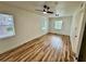 Bright bedroom featuring new light fixture, modern ceiling fan, and beautiful wood-look flooring at 300 Dalton Blvd Blvd, Port Charlotte, FL 33952